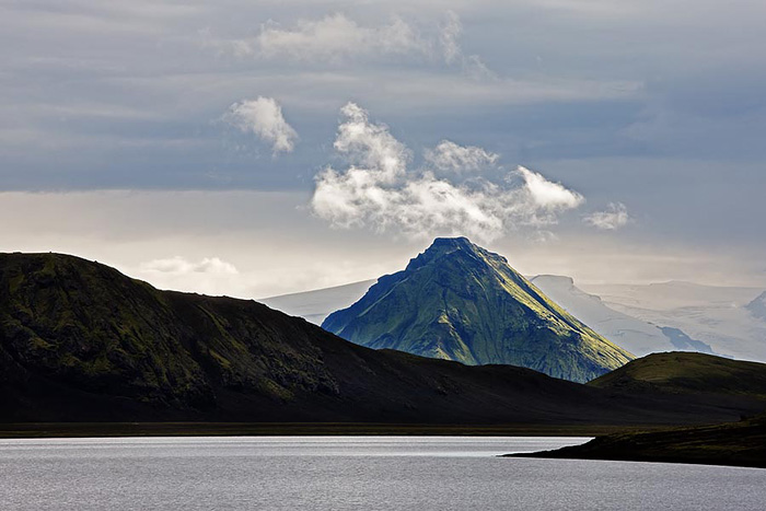 Dark and light forms of water, lava, and clouds combine to create a diverse landscape in southern Iceland.&nbsp;