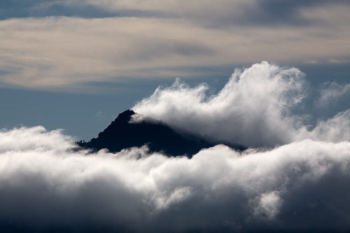 Clouds were whipping by this peak in a strong wind, and they piled up on the backside to make for an interesting composition. &...