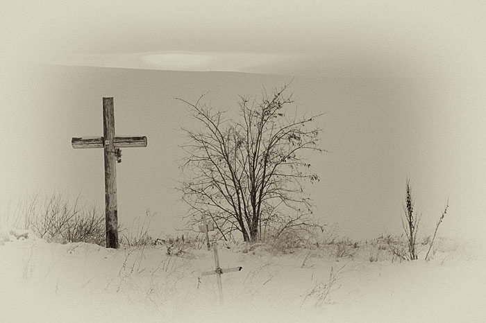 A large wooden cross marks the location of an old and declining pioneer cemetery in Umatilla County, Oregon, in an area surrounded...